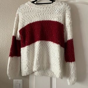 White sweater with red stripe